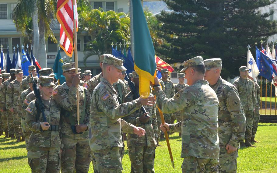 Gen. Charles Flynn, right, commander of U.S. Army Pacific, hands the colors of the third Multi-Domain Task Force to Col. David Zinn during a ceremony at Fort Shafter, Hawaii, Friday, Sept. 23, 2022.