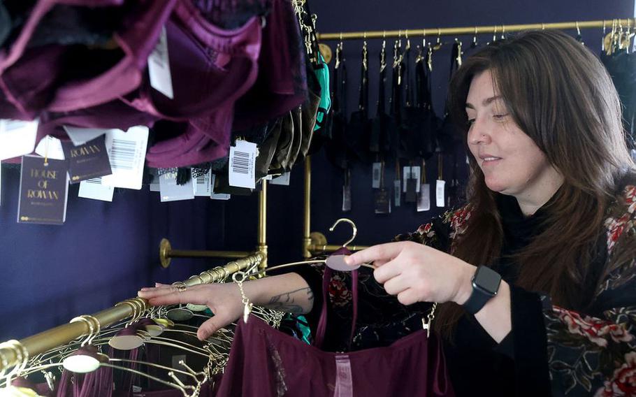 Adrian Rowan arranges the stock in the lingerie boutique, House of Rowan, in the room adjacent to her photography studio, Jan. 18, 2022.