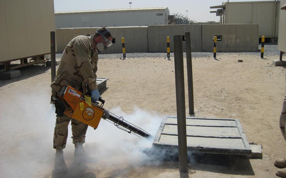 In this 2010 photo, Navy Lt. Michael Fisher sprays mosquito repellent at Camp Buehring in Kuwait. Now, scientists at the University of Florida have developed a device for the military that can keep mosquitoes at bay for a month.