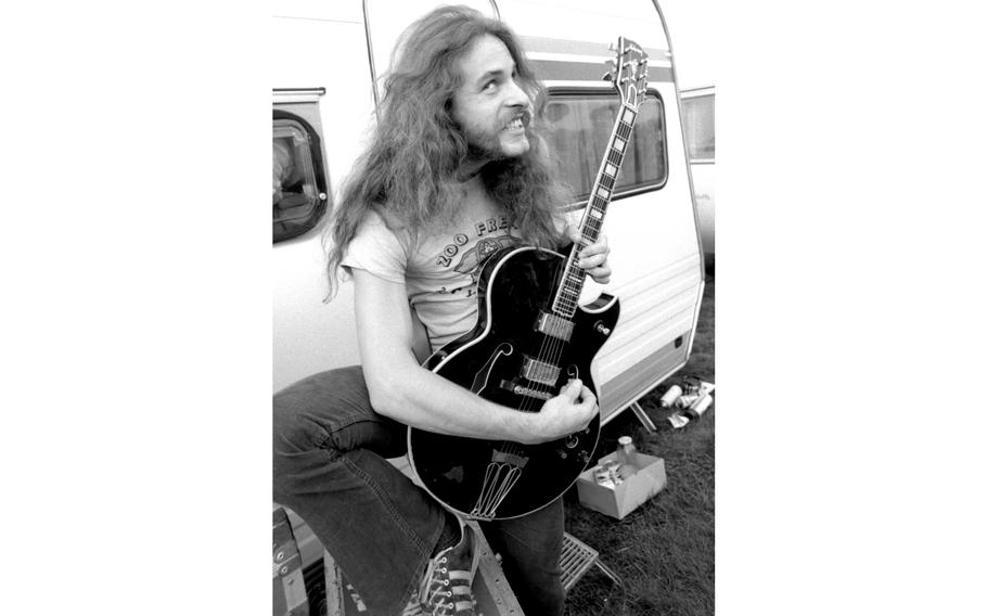 A man plays guitar