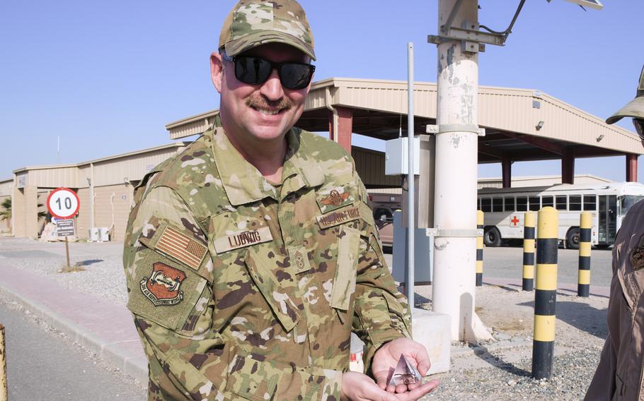 Air Force Chief Master Sgt. Louis Ludwig shows off a scorpion encased in resin that he received after a morale trip into the desert around Ali Al Salem Air Base in Kuwait to capture venomous creatures such as this one.