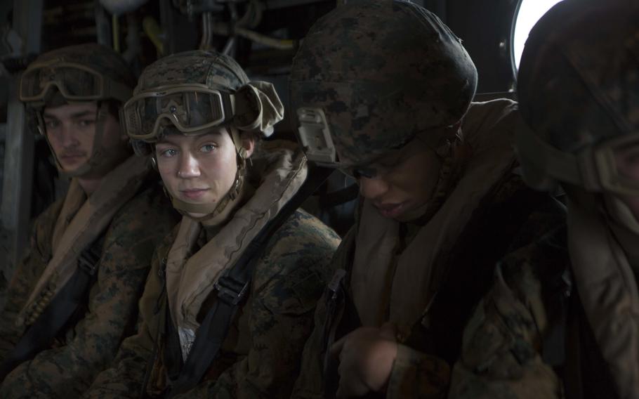 Marine Corps Cpl. Nicole Gee, second from left, a maintenance technician with 24th Marine Expeditionary Unit, awaits the launch of an MV-22B Osprey during an exercise aboard the Wasp-class amphibious assault ship USS Iwo Jima on April 5, 2021. 