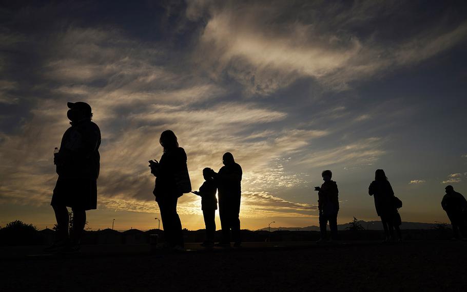 People wait in line to vote at a polling place before it opened on Election Day, Tuesday, Nov. 3, 2020, in Las Vegas. (AP Photo/John Locher)