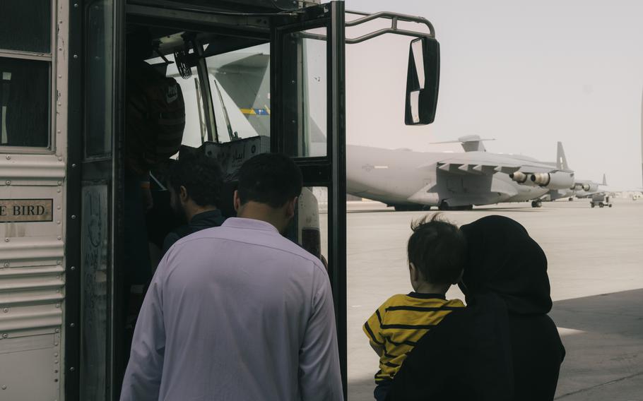 People walking on to a bus.