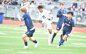 Naples' Joshua Banks gets off a shot before Black Forest Academy defenders, from left, Jack Cox, Thomas Brady and Jongiln Park can stop him on Saturday, April 19, 2025, in Vicenza, Italy.

Kent Harris/Stars and Stripes 
