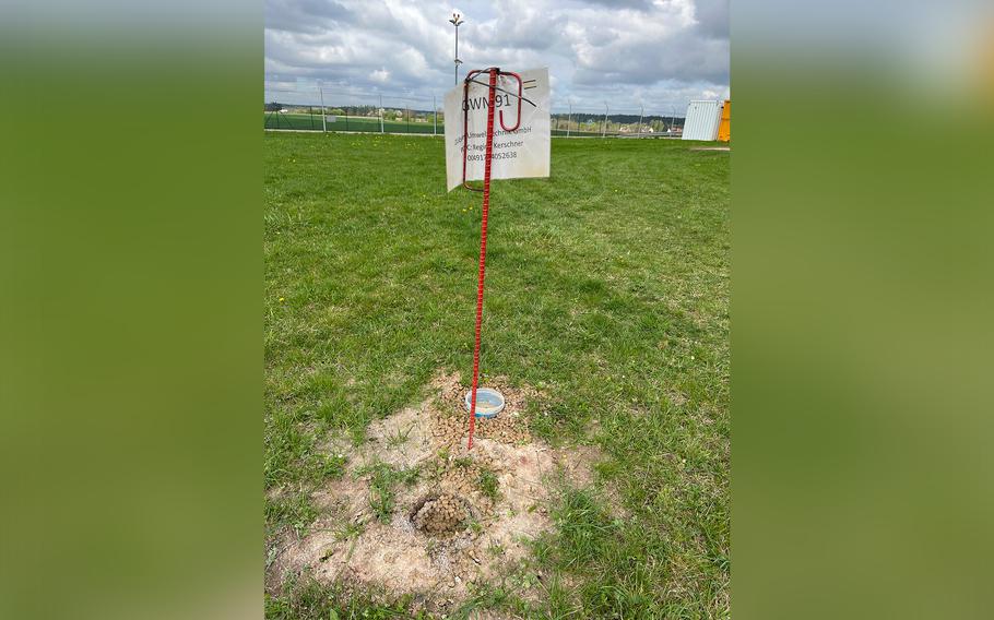 Flags mark planned extraction wells around a concrete pad where firefighter training used to take place at U.S. Army Garrison Ansbach in Germany on April 10, 2024. The area's groundwater is now contaminated with toxic PFAS and must be pumped and purified before it is allowed to flow off base.  