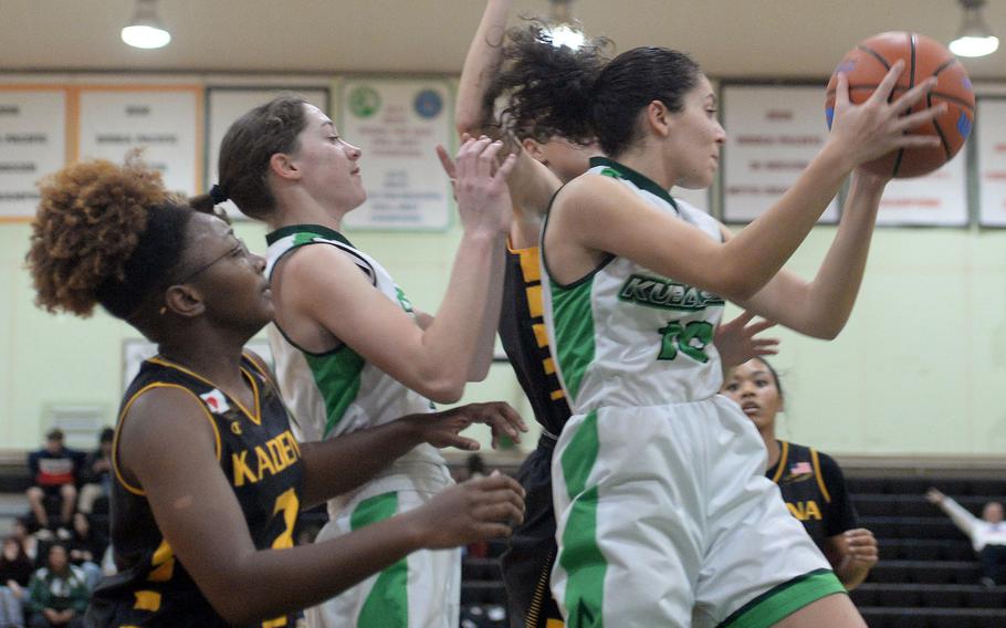 Kubasaki's Sophia Grubbs snags a rebound in front of Kadena's Destiny Richardson during Thursday's Okinawa girls basketball game. The Panthers won 36-19.