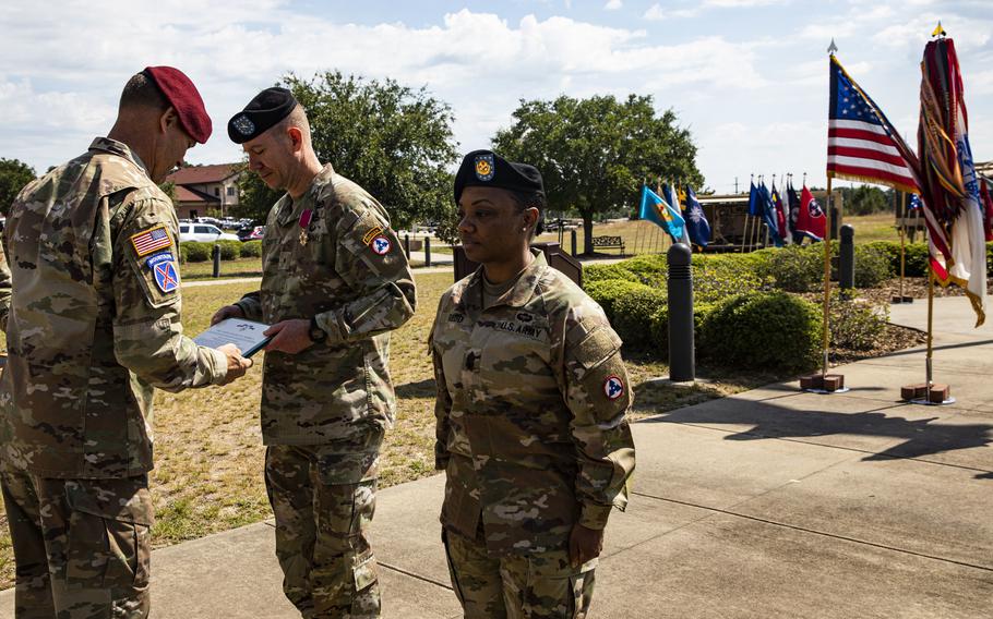 U.S. Army Maj. Gen. Brian Mennes, Deputy Commanding General of the XVIII Airborne Corps, presents The Legion of Merit Award to Brig. Gen. Lance Curtis, outgoing commander, 3rd Expeditionary Sustainment Command, XVIII Airborne Corps and Command Sgt. Maj. Phelicea Redd, outgoing command sergeant major, at the 3rd ESC Change of Command and Relinquishment of Responsibility on Fort Bragg, N.C., June 10, 2022. During the ceremony Col. John (Brad) Hinson assumed command of the 3rd ESC from Curtis.