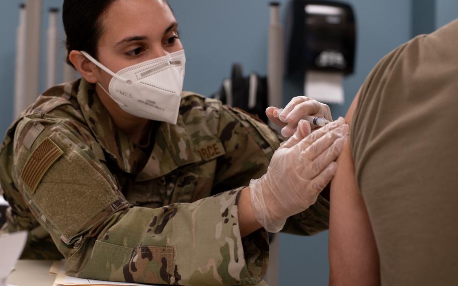 Tech. Sgt. Rachel Clark, an aerospace medical technician with the 137th Special Operations Medical Group, administers a coronavirus vaccine to an Oklahoma National Guard soldier at the Armed Forces Reserve Center in Norman, Okla., on Jan. 15, 2021. 