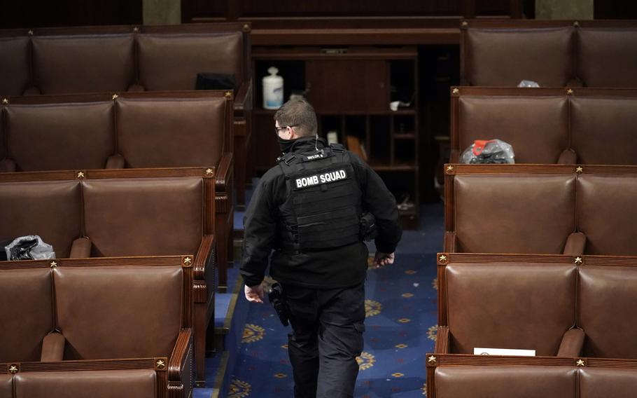 A member of the bomb squad walks on the House floor after rioters who support President Donald Trump broke into the U.S. Capitol on Jan. 6, 2021, in Washington. Intelligence reports compiled by the U.S. Capitol Police in the days before last year’s insurrection envisioned only an improbable or remote risk of violence, even as other assessments warned that crowds of potentially tens of thousands of pro-Trump demonstrators could converge in Washington to create a dangerous situation.