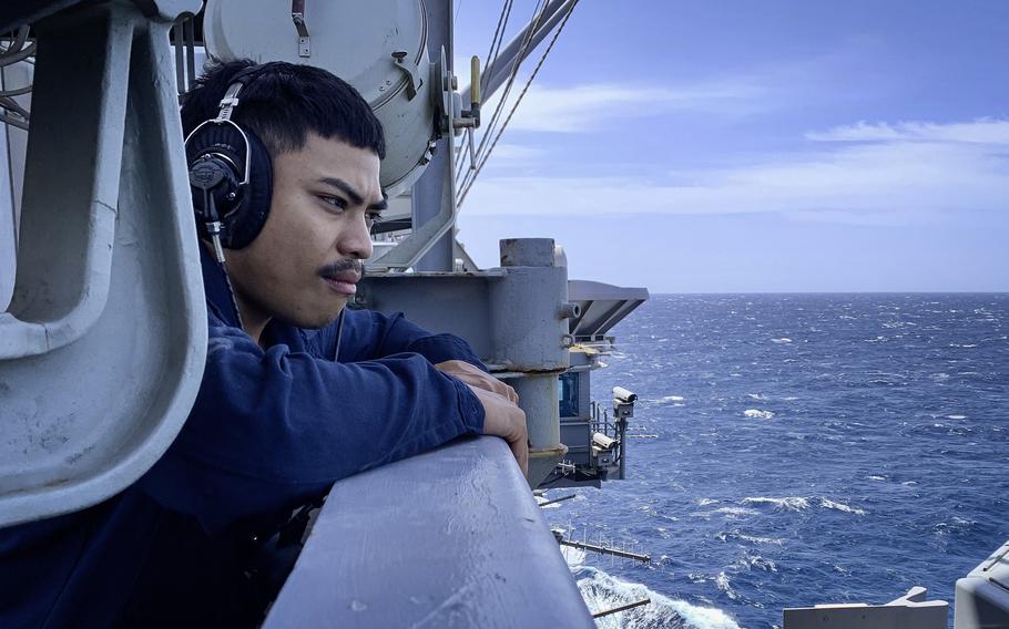 A sailor stands watch aboard the aircraft carrier USS Dwight D. Eisenhower in the Red Sea, on March 20, 2024. The crew of the aircraft carrier has seen nearly five months at sea without a port call.