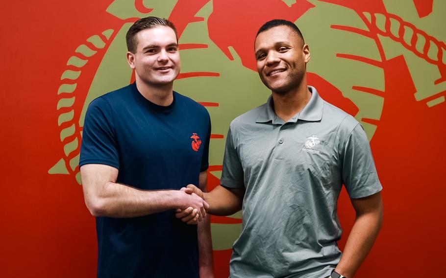 Former Army Capt. Nicholas Brooklier, left, and Marine Corps Staff Sgt. Lafeyette Halmon pose for a photo at a recruiting substation in Killeen,  Texas, Jan. 31, 2024. Brooklier left the Army to enlist in the Marines. 