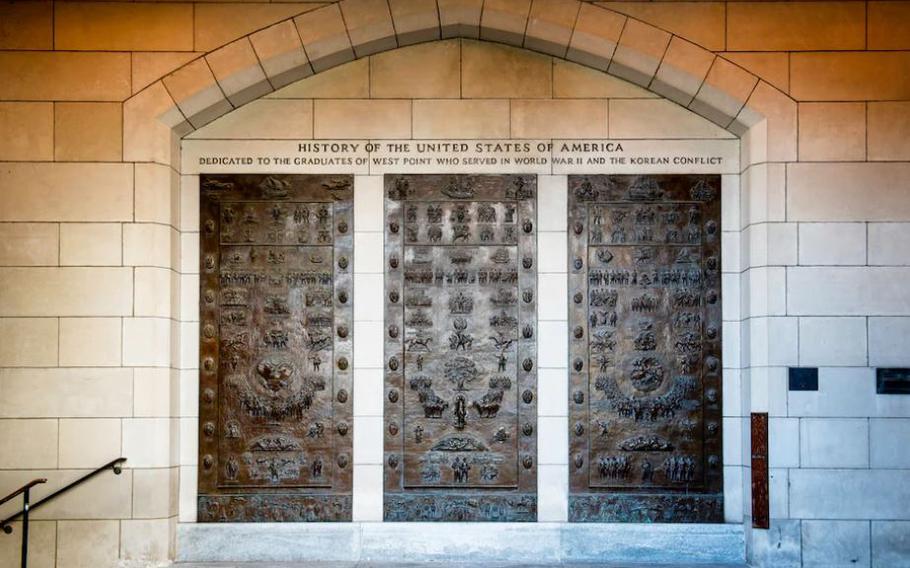 One of the figures depicted in these bronze panels at the U.S. Military Academy at West Point, N.Y., is a hooded Klansman. 