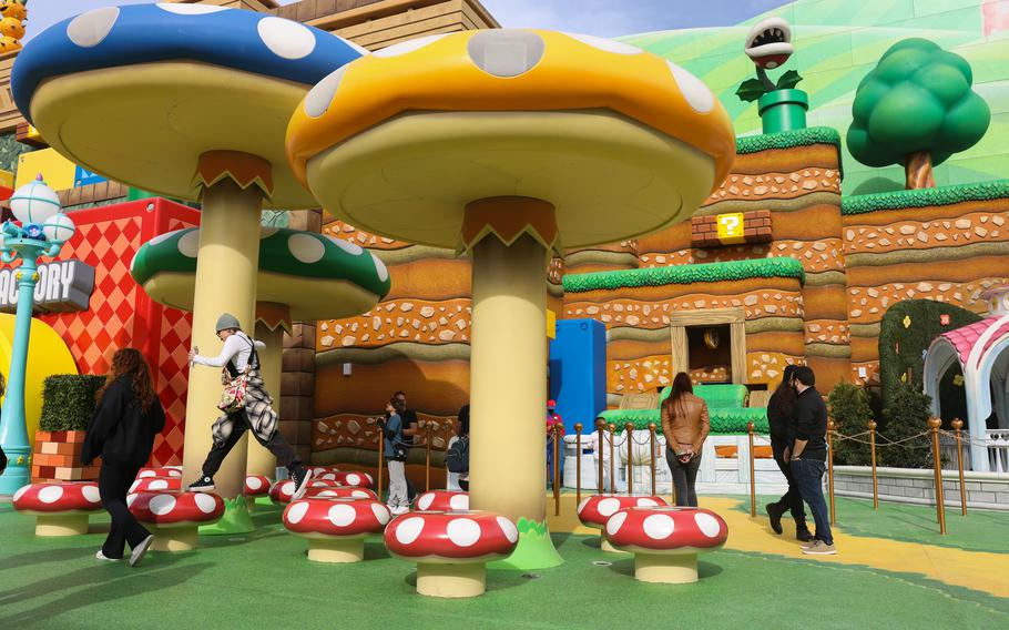 People play on top of the large mushrooms Jan. 12 during technical rehearsals for Super Nintendo World. At the park guests should feel like they’re inside a game rather than visiting a place filled with games.  
