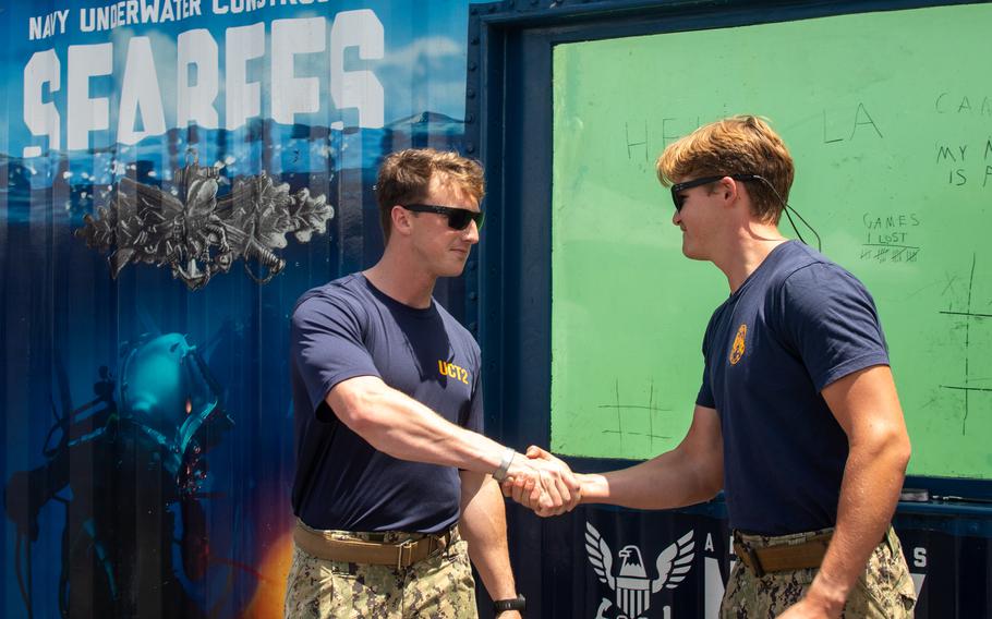 Two sailors shake hands