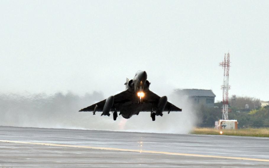 a fighter jet lifts off from a runway