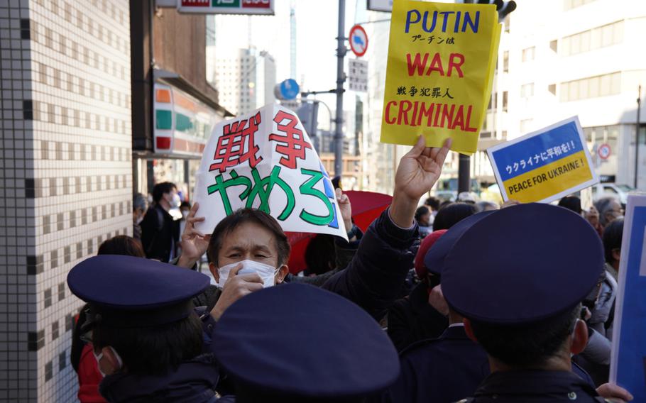 Japanese police block anti-war protesters from reaching the Russian embassy in Tokyo, Friday, Feb. 25, 2022.
