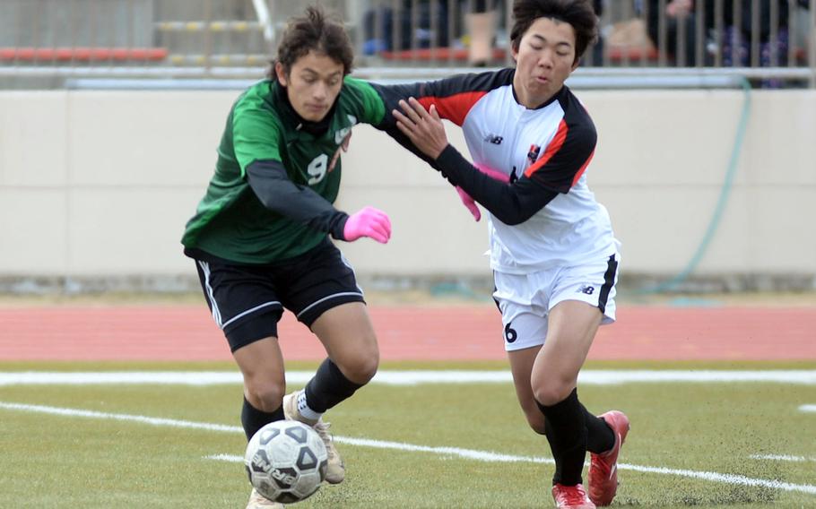 Kubasaki's Matthew Yulee and Nile C. Kinnick's Takuya Raqueno battle for the ball during Saturday's Perry Cup Golf Group playoff match. The Red Devils won 3-2.