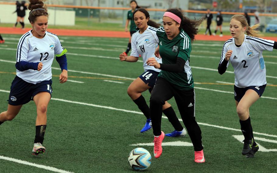 Daegu’s Jaela Sahagun dribbles past the Osan defense during Thursday’s DODEA-Korea soccer match. The teams battled to a 2-2 draw.