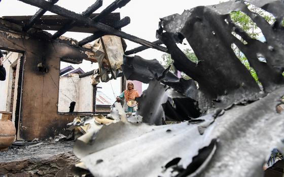 A woman stands in front of her damaged house following cross-border shelling between Pakistani and Indian forces in Salamabad uri village at the Line of Control (LoC), on May 8, 2025. (Basit Zargar/Middle east images via AFP/Getty Images/TNS)