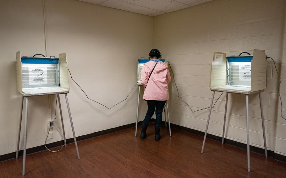 A voter casts an absentee ballot during early presidential election voting in Detroit in October 2020. 