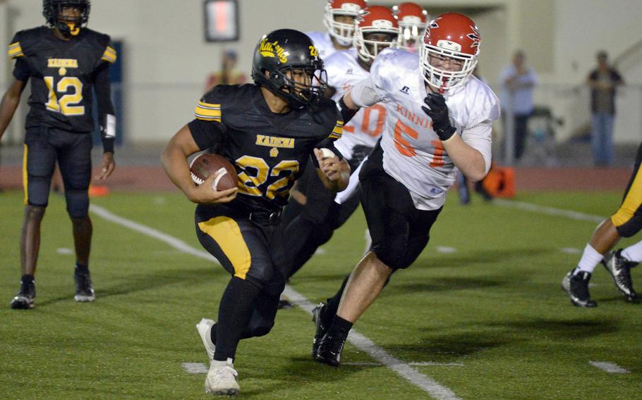 Kadena's Jeremiah Drummer tries to elude Nile C. Kinnick's Braden Askins.