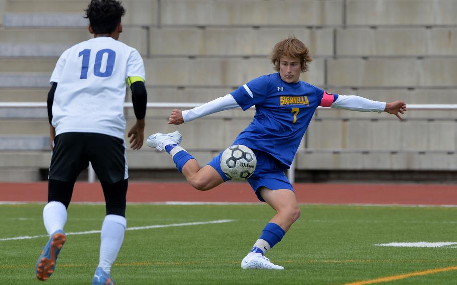 Sigonella’s Tim Garcia takes a shot on goal as Brussels’ Ezra De Leon Kona watches. Sigonella defeated Brussels 6-0 in a Division III semifinal at the DODEA-Europe soccer finals in Kaiserslautern, Germany, May 17, 2023. 