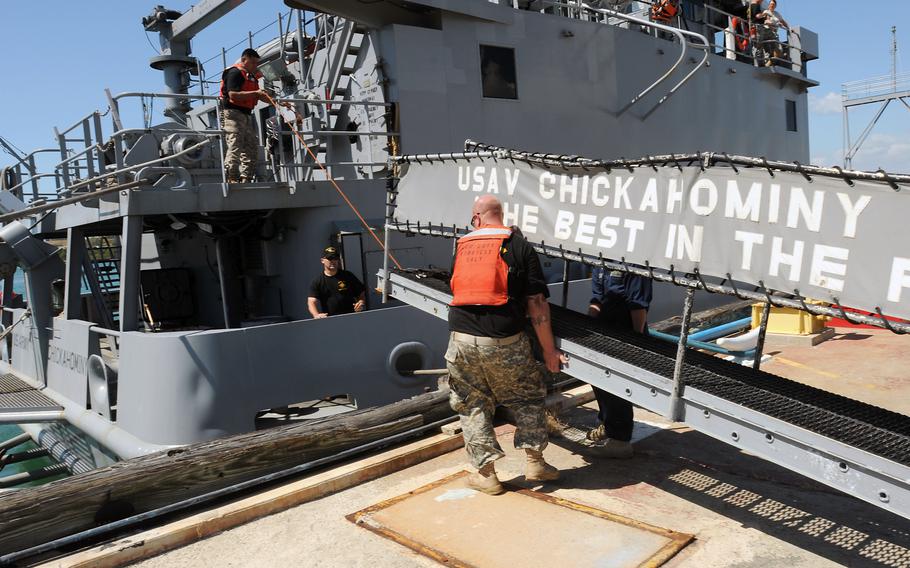 Crew members of the USAV Chickahominy, a landing craft, set up the gangway after mooring at Naval Station Guantanamo Bay, Cuba, in 2011.  The Chickahominy and four other Army landing craft were identified by a commission to have their names scrubbed of references to the Confederacy, according to a report submitted to Congress on Monday, Sept. 19, 2022.