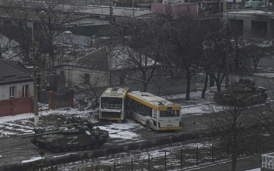 Russian’s army tanks move down a street on the outskirts of Mariupol, Ukraine, on Friday, March 11, 2022. 