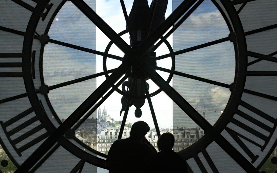 A couple looks out across Paris toward Sacre Coeur basilica through the clock at the Musee d’Orsay. The European Travel Information and Authorization System will be implemented next year, and U.S. service members will have to submit personal information to seek authorization to travel to much of Europe.