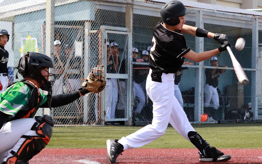 ASIJ's Ray Takizawa connects in front of Kubasaki catcher Skylar Waltz.