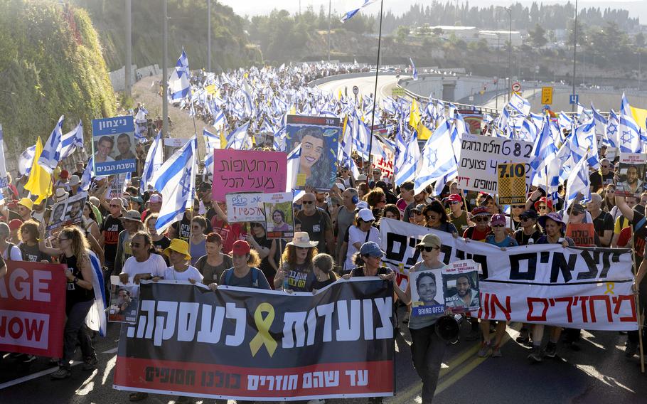 Families of hostages lead a protest march calling for a hostage deal on July 13, 2024, in Jerusalem. 