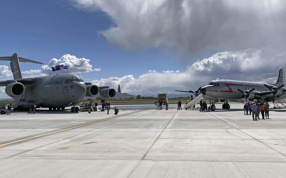A C-17 Globemaster III and a C-54 Skymaster sit beside each other in Provo, Utah, May 20, 2022. The C-17 was renamed to "Spirit of the Candy Bomber" in Provo, Utah, May 20, 2022, to honor Gail Halvorsen of Berlin Airlift fame.Halvorsen, a Utah native, flew C-54s during the airlift.