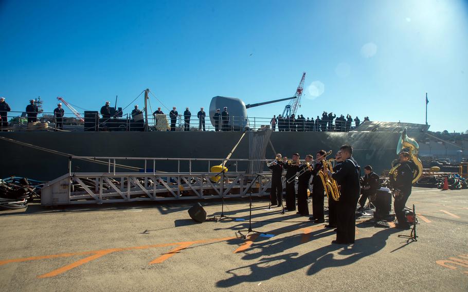 Members of the U.S. 7th Fleet band perform for the USS Antietam as it departs Yokosuka Naval Base, Japan, Jan. 26, 2024. The guided-missile cruiser is shifting its homeport to Pearl Harbor, Hawaii.