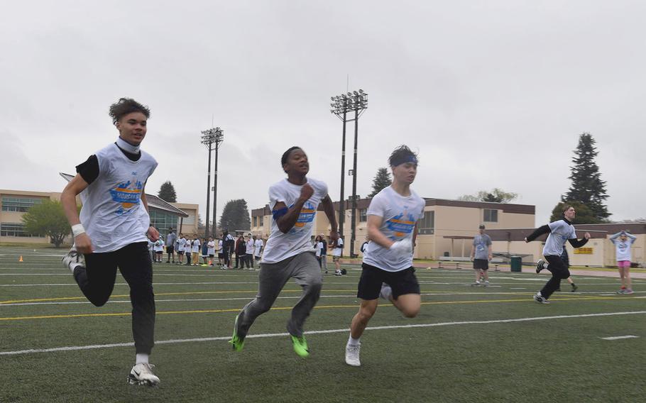 Young athletes run a 40-yard dash during a camp.