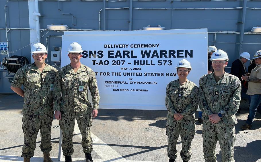 From left: Cmdr. Mark Ewachiw, supervisor of shipbuilding, Bath-San Diego Detachment, officer in charge; Lt. Elliot Collins, project officer; Lt. Allison Adamos, project officer; and Lt. Cmdr. René Martin, T-AO program manager representative attend the USNS Earl Warren delivery ceremony on Tuesday, May 7, 2024, in San Diego.