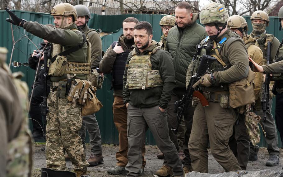 Ukrainian President Volodymyr Zelenskyy examines the site of a recent battle in Bucha close to Kyiv, Ukraine, Monday, April 4, 2022. 