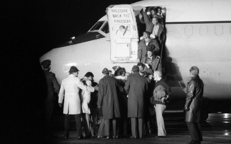 Officials greet the so-called Iran hostages as they step out of one of the two C-9 planes that ferried them from Tehran, Iran, to Rhein-Main Air Base in Germany.