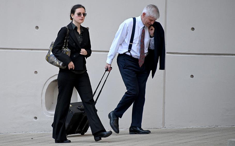 Dr. Anna Gabrielian walks with her lawyer, Christopher Mead, into federal court. Garbrielian is standing trial this week along with her spouse, Dr. Jamie Lee Henry, an Army veteran, in federal court in Baltimore on allegations that they conspired to provide confidential patient medical records to Russia after its invasion of Ukraine.