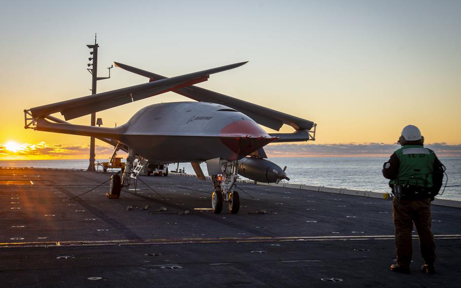 A Boeing unmanned MQ-25 aircraft is given operating directions on the flight deck aboard the aircraft carrier USS George H.W. Bush (CVN 77) on Dec. 13, 2021.