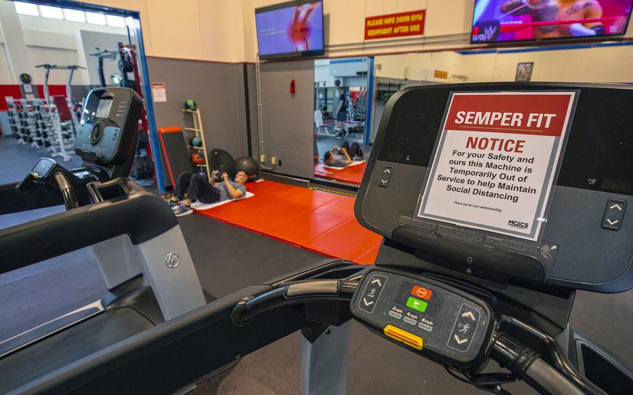 A sign urges gymgoers to practice social distancing to combat the spread of the coronavirus earlier this spring at Marine Corps Air Station Iwakuni, Japan. 