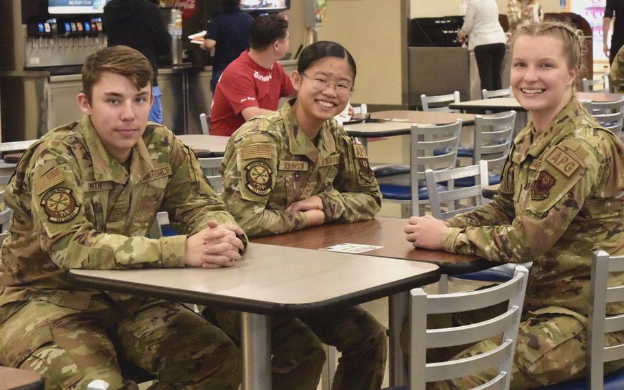 Air Force Airman 1st Class Kira Johnson, 18, center, shown here with Airmen 1st Class Brandon Smith, 19, left, and Emma Abrams 19, at Kadena Air Base, Okinawa, Japan, on Dec. 22, 2022, resolved to become a journeyman crew chief with the 353rd Air Force Special Operations Command in 2023.  