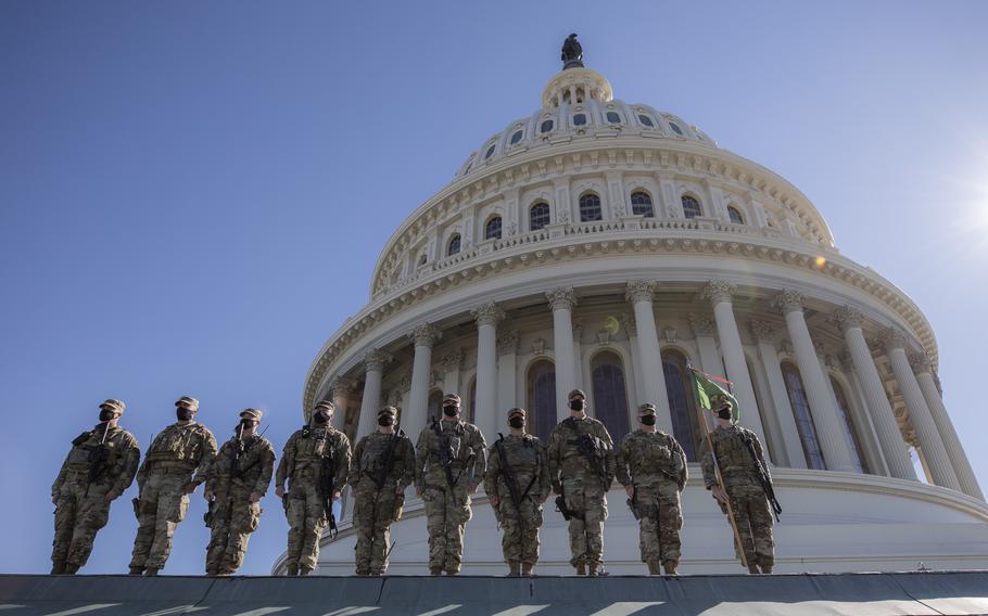 U.S. Soldiers with the 46th Military Police Company, Michigan National Guard, pose for a photo on top of the U.S. Capitol building in Washington, D.C., Feb. 25, 2021. A Missouri man left a loaded 9mm semiautomatic pistol on the grounds of the U.S. Capitol on Jan. 6, 2021, according to prosecutors.