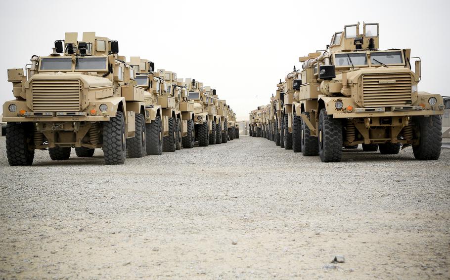 Marine Corps Mine-Resistant Ambush Protected armored vehicles await washing at Camp Leatherneck in Helmand province, Afghanistan, April 3, 2014. 