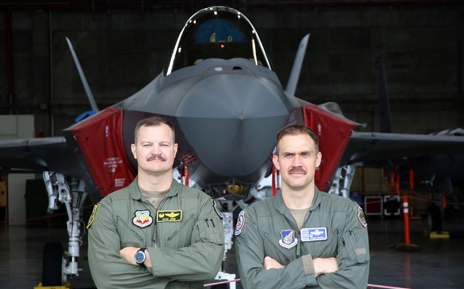Lt. Col. Jeremiah King, left, commander of the 391st Fighter Squadron, and Lt. Col. Michael Mickus, commander of the 355th Fighter Squadron, pose with an F-35A Lightning II stealth fighter deployed temporarily to Kadena Air Base, Okinawa, Friday, June 16, 2023. 