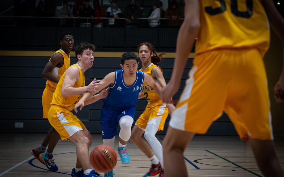 Marymount’s Jianshen Wu pushes ahead against Vicenza defenders at the DODEA-Europe Division II boys basketball tournament Wednesday, Feb. 15, 2023. During the first game of the event, Vicenza beat Marymount 38-26.