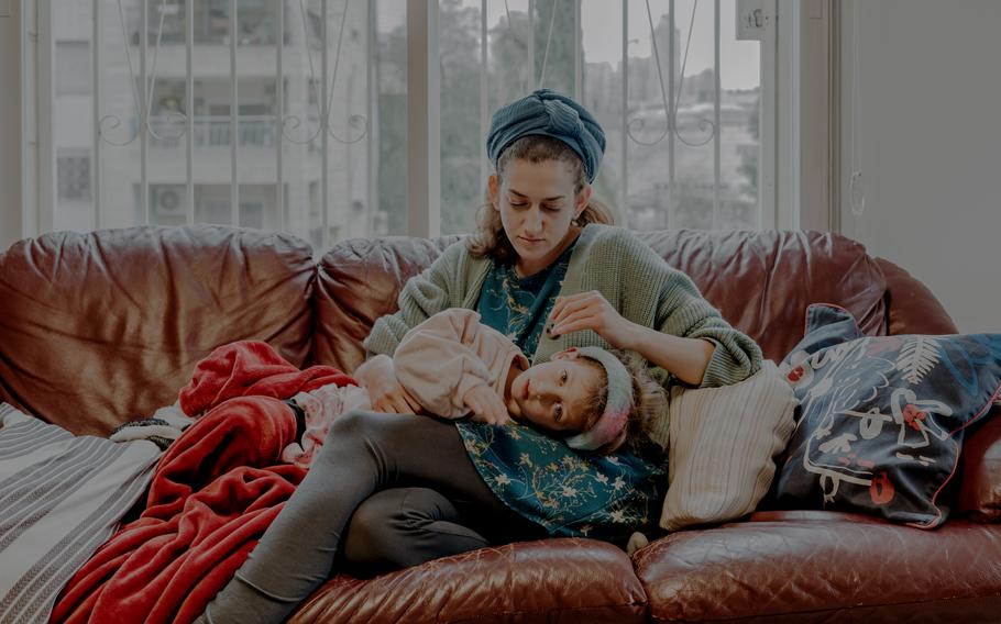 Pesi Gordon with daughter Livi at their home in Jerusalem. Naftali Yonah Gordon, Pesi’s husband, was killed Dec. 7 while fighting in Gaza. 