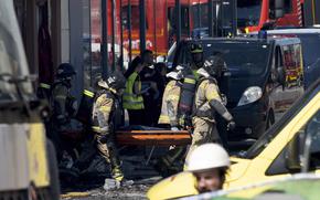 Firefighters carry out a covered body on a stretcher after a fire in a nightclub after at least 13 people were killed in a fire in a Spanish nightclub in Murcia, Spain Oct. 1, 2023.