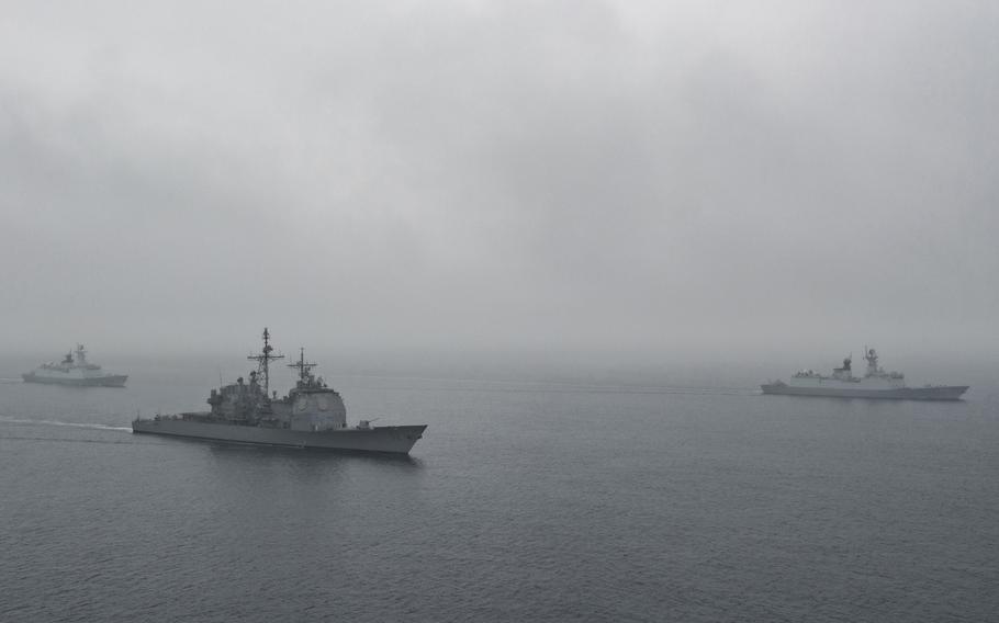 The cruiser USS Bunker Hill participates in an exercise with Chinese navy frigates off the coast of California in 2016. The world’s militaries collectively produce about 5.5% of all greenhouse gas emissions, according to new research. 