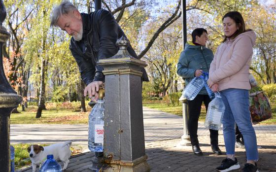 Residents of Kyiv, Ukraine, line up to fill water jugs from a public fountain in Taras Shevchenko Park after a Russian missile strike Oct. 31, 2022, left about 80% of the city without water.